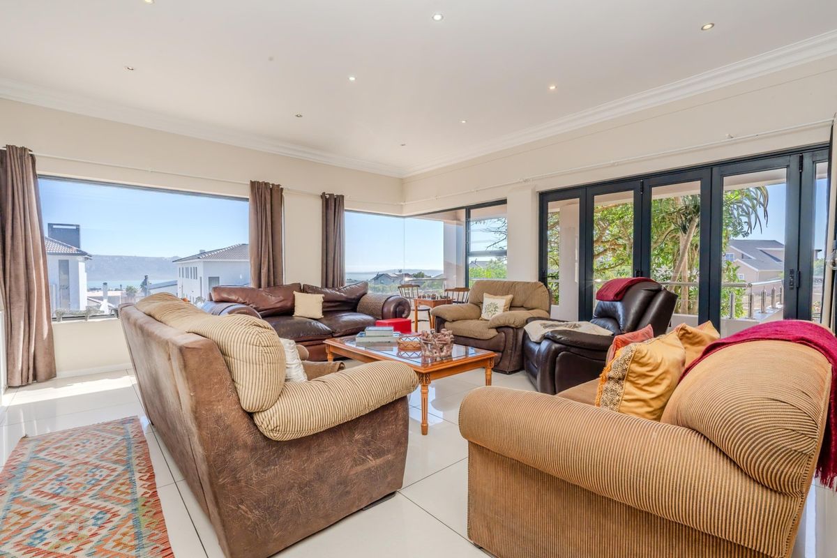 Spacious living room featuring large picture windows and sliding glass doors that provide abundant natural light and scenic views.