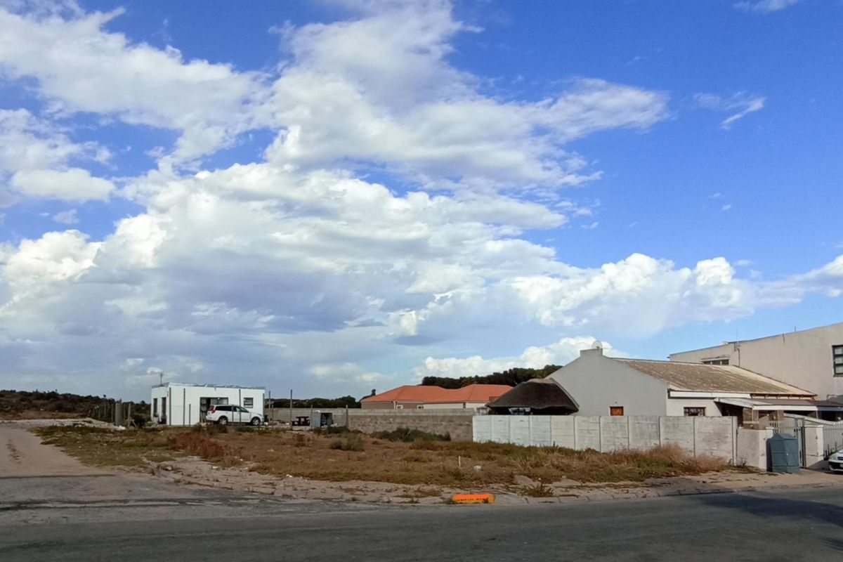 A vacant residential plot situated in a developed neighborhood with established boundary walls and direct street access.