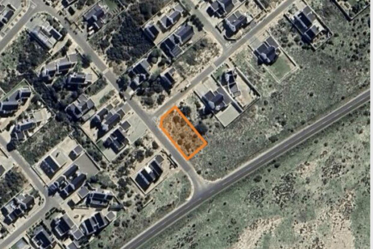 An aerial view of a vacant residential plot highlighted in orange, situated within an established suburban neighborhood.