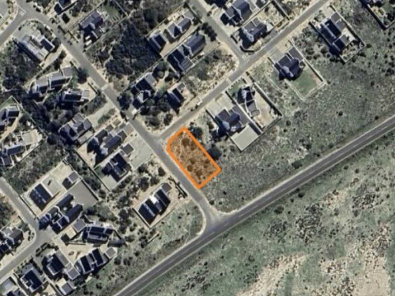 An aerial view of a vacant residential plot highlighted in orange, situated within an established suburban neighborhood.