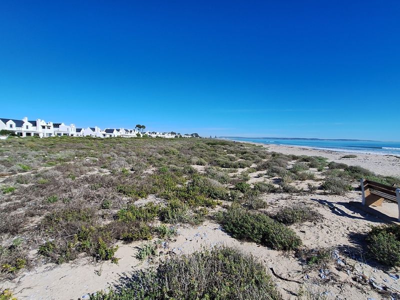 A scenic view of the coastal landscape and beachfront, showcasing the natural surroundings and proximity to the ocean.