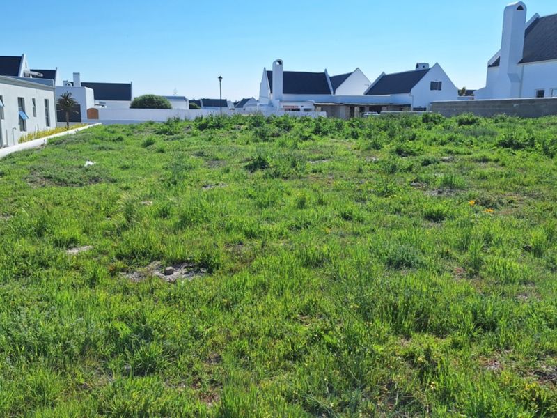 A vacant residential plot of land situated in a developed neighborhood, ready for new construction.