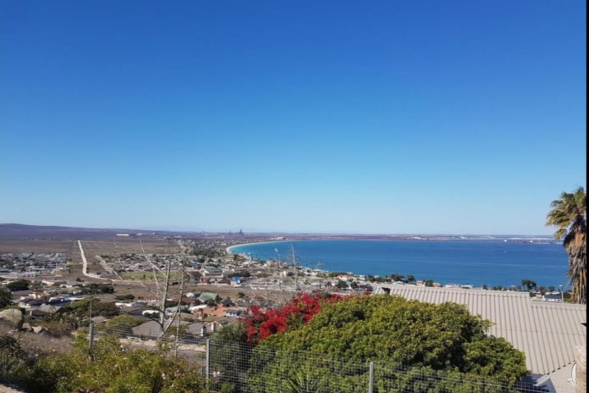 Elevated panoramic view overlooking the coastline, bay, and surrounding residential area.