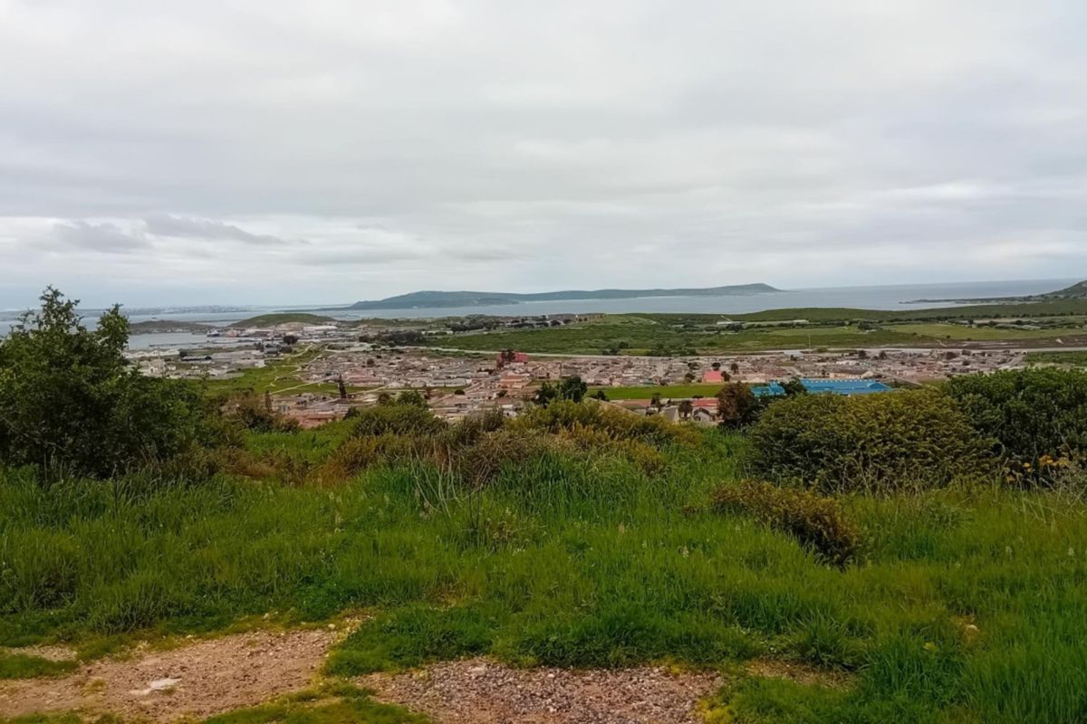 Elevated panoramic view overlooking the surrounding landscape, coastal town, and distant ocean horizon.