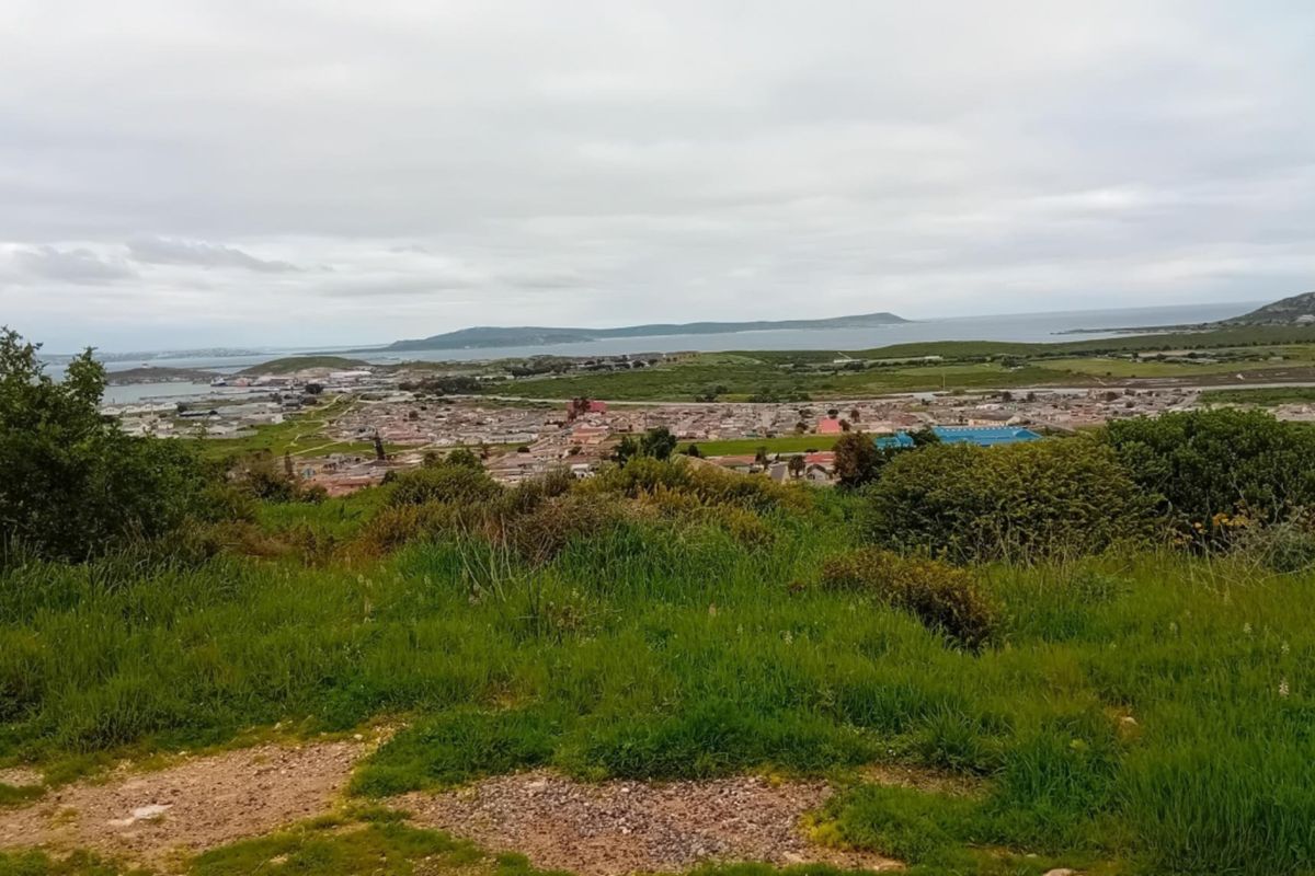 An elevated panoramic view overlooking the surrounding coastal landscape, residential area, and distant bay.
