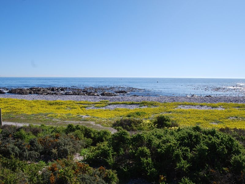 A scenic view of the ocean and coastal landscape, showcasing the natural beauty and direct water frontage of the vacant land.