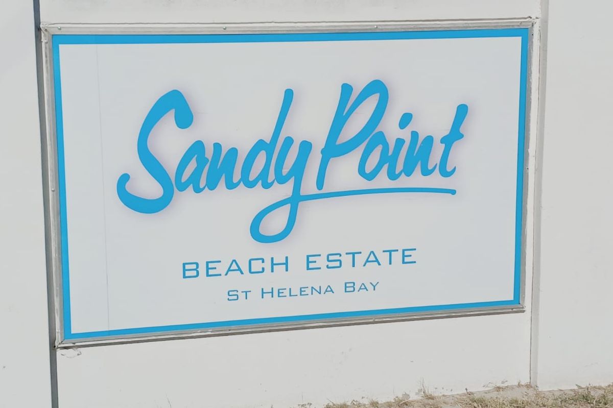 A clear signage board identifying the Sandy Point Beach Estate in St Helena Bay.