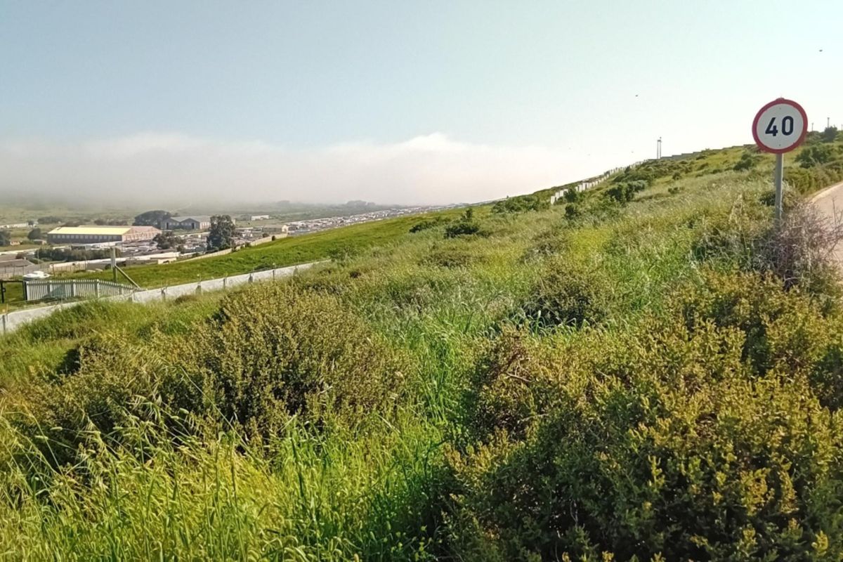 A view of the surrounding landscape and local road infrastructure adjacent to the vacant residential land.