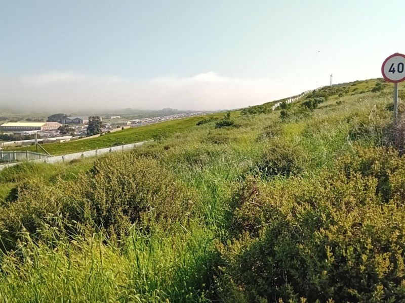 A view of the surrounding landscape and local road infrastructure adjacent to the vacant residential land.