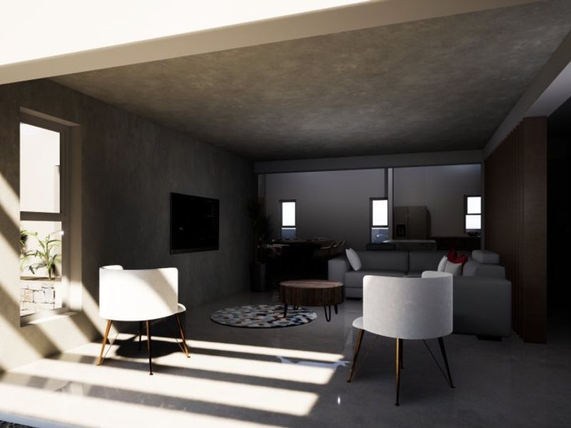 Modern open-plan living area featuring polished concrete floors, a sleek concrete ceiling, and large sliding doors opening to an outdoor space.