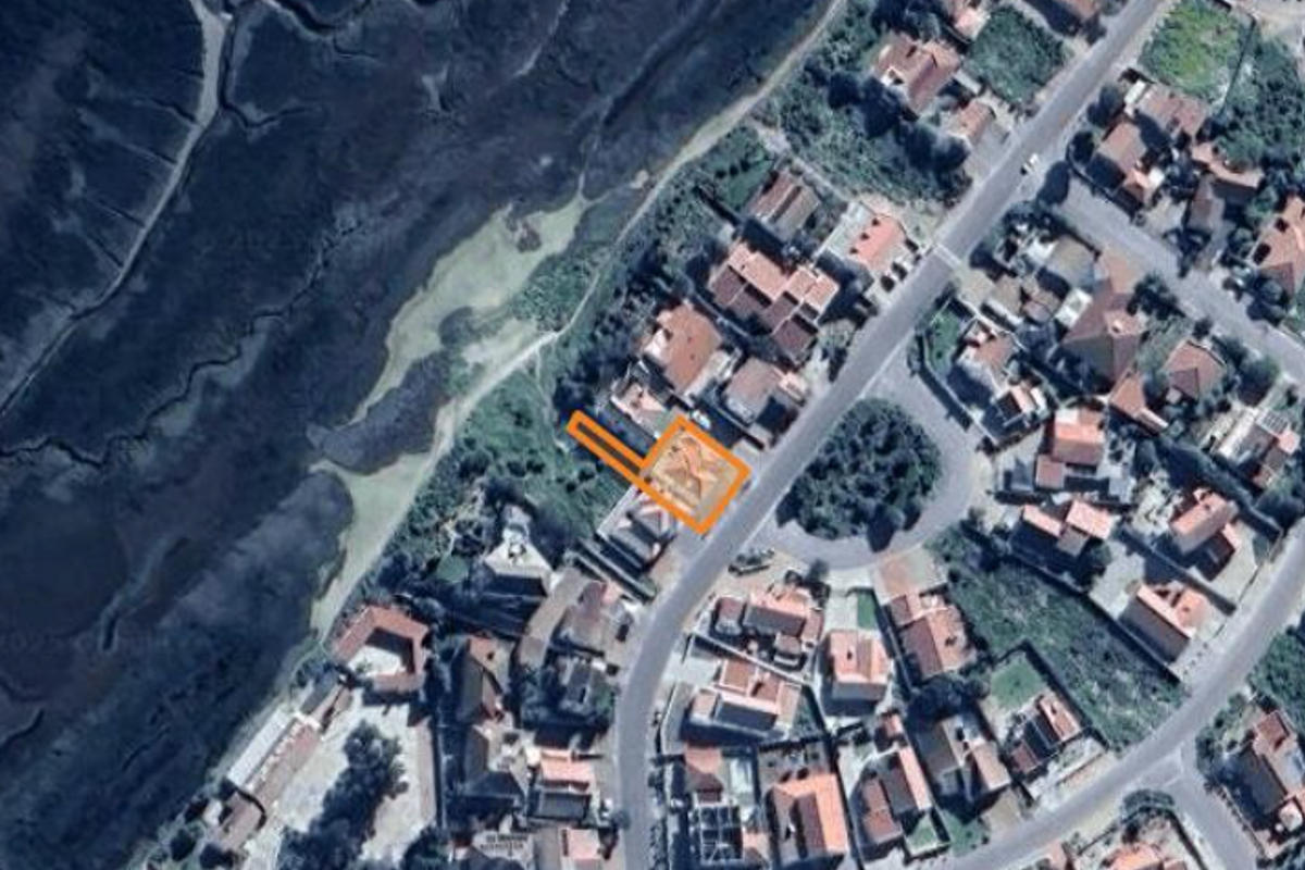 An aerial satellite view showing the property location within the residential neighborhood and its proximity to the adjacent coastal area.