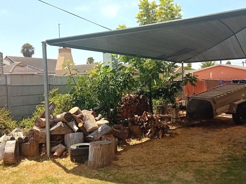Rear outdoor area featuring a shade cloth structure and precast concrete boundary wall.
