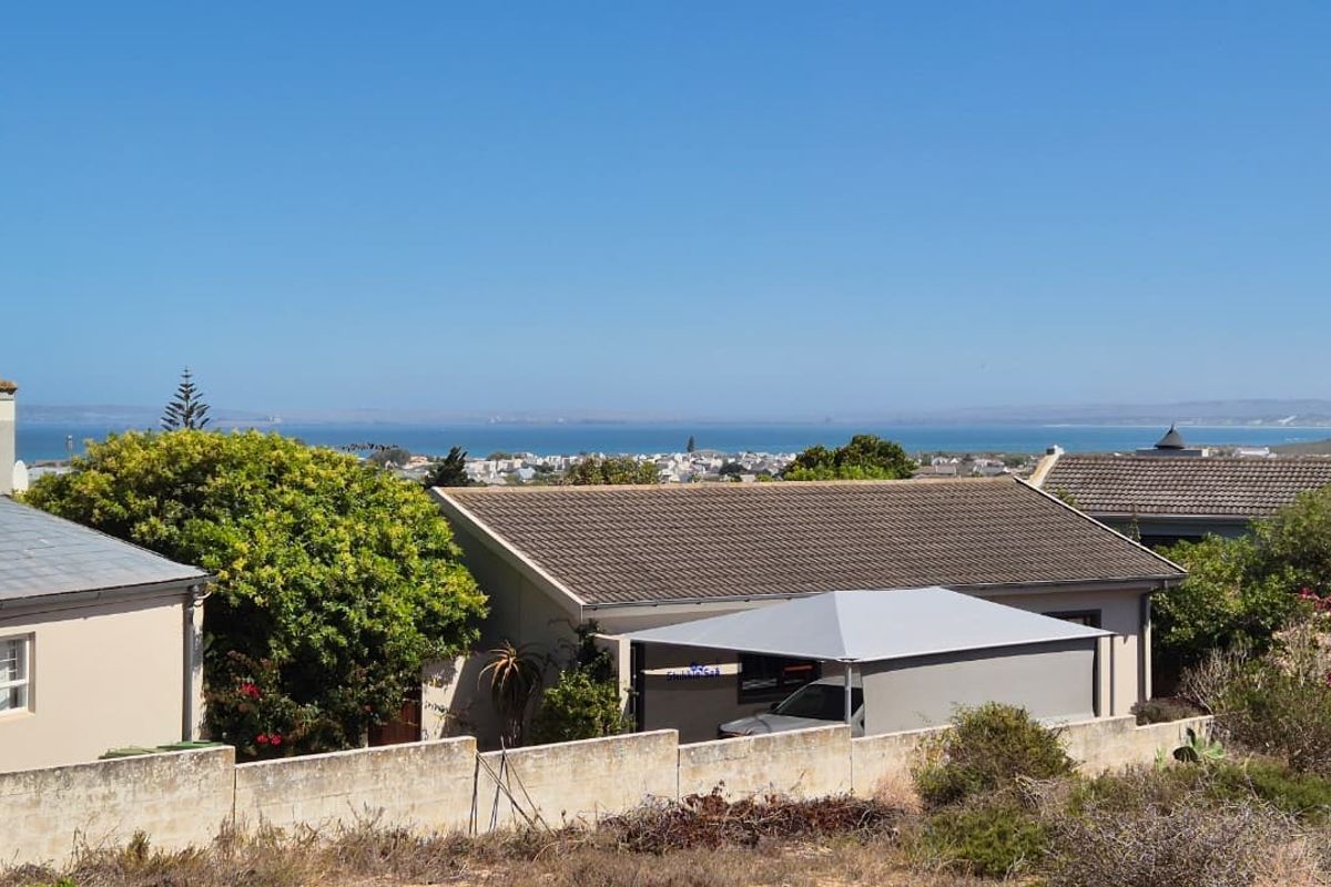A scenic elevated view overlooking a coastal residential neighborhood and the ocean horizon.