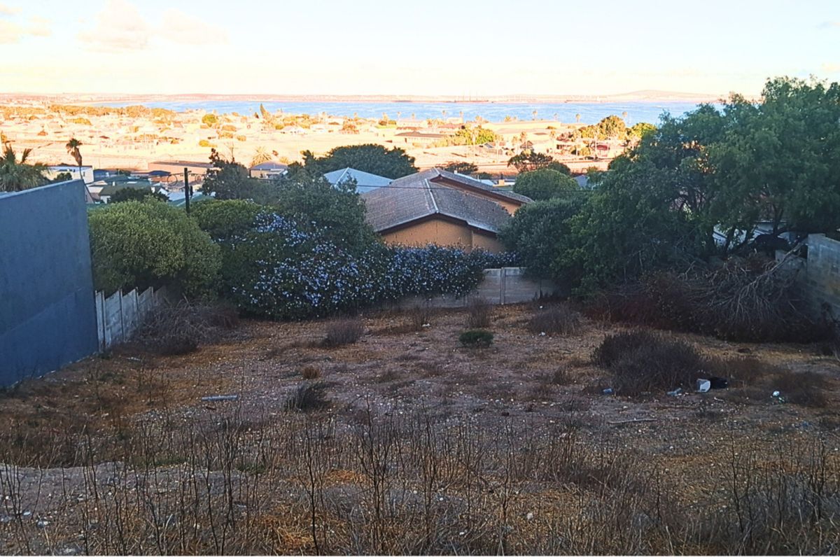 Elevated view overlooking the residential area and coastline, showcasing the potential of this vacant land plot.