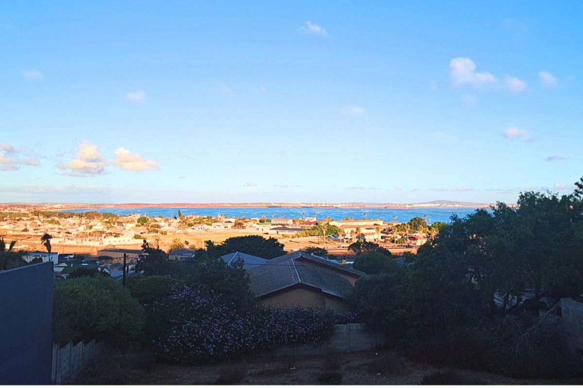 A scenic elevated view overlooking a coastal residential area and the ocean horizon.