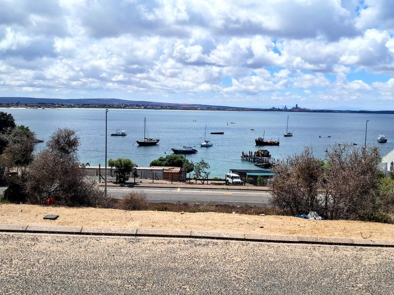 A scenic elevated view overlooking the bay, harbour, and surrounding coastal landscape.