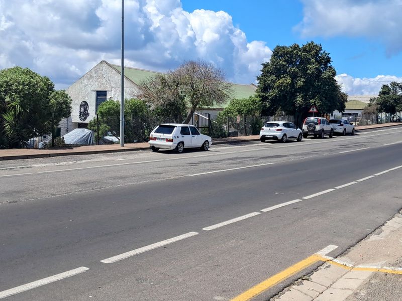 A street-level view showing the road infrastructure, adjacent fencing, and surrounding neighborhood context.