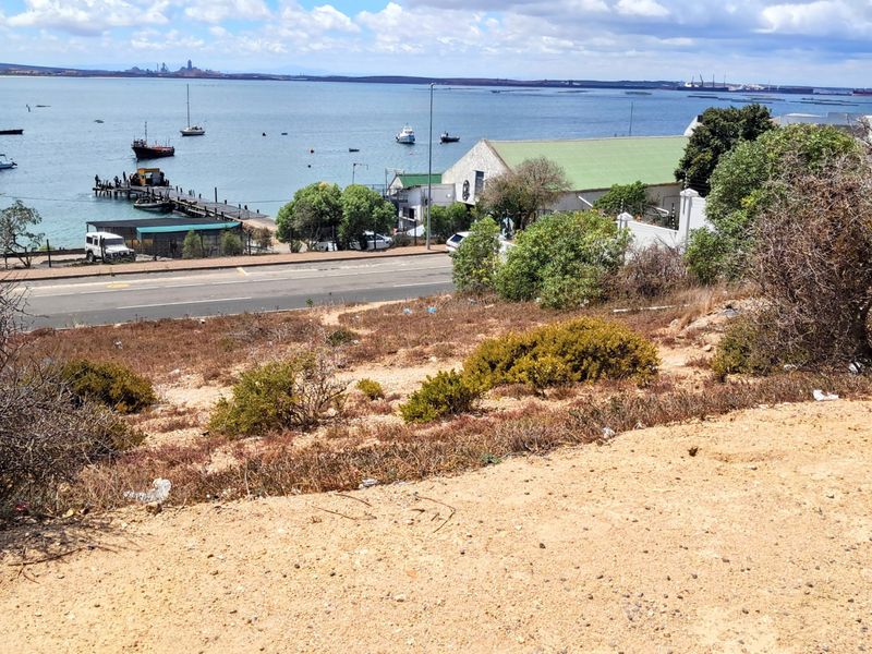 Elevated view overlooking the coastal harbour, bay, and surrounding landscape from the vacant residential plot.