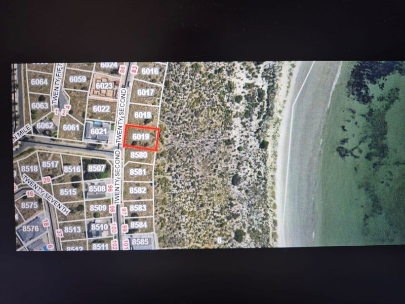 An aerial map view highlighting a specific residential vacant land plot within a coastal subdivision.
