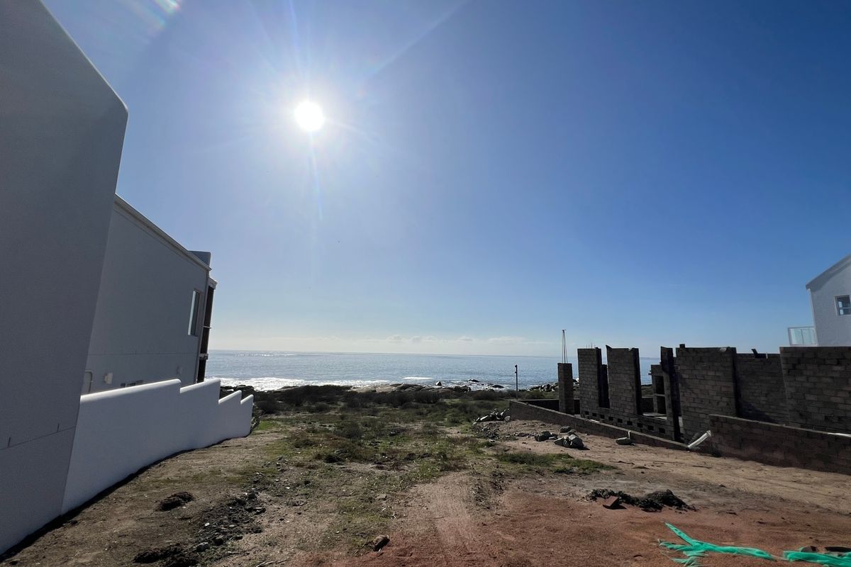 A wide-angle view of the ocean and coastal landscape from the residential property site.