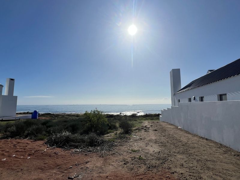A scenic view of the ocean from the property, showcasing the coastal landscape and surrounding residential structures.