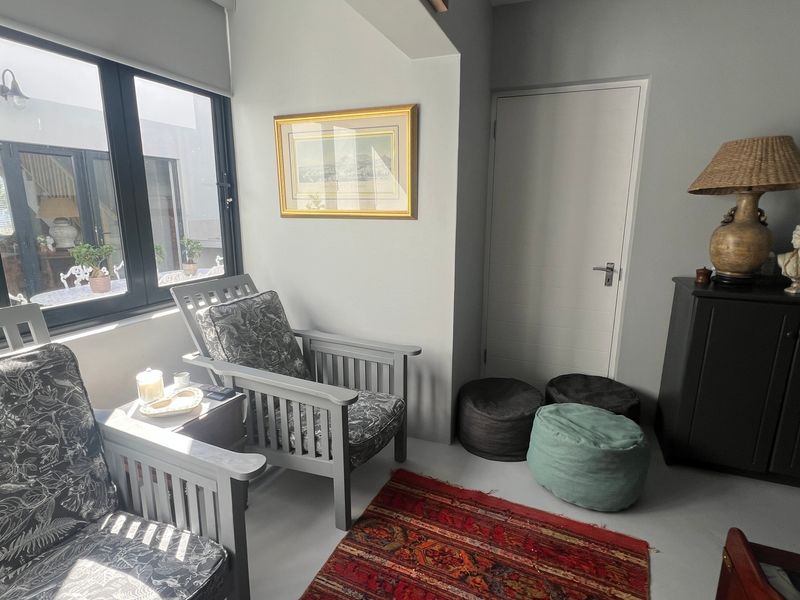 A cozy living area featuring a large window with natural light and a neutral interior finish.