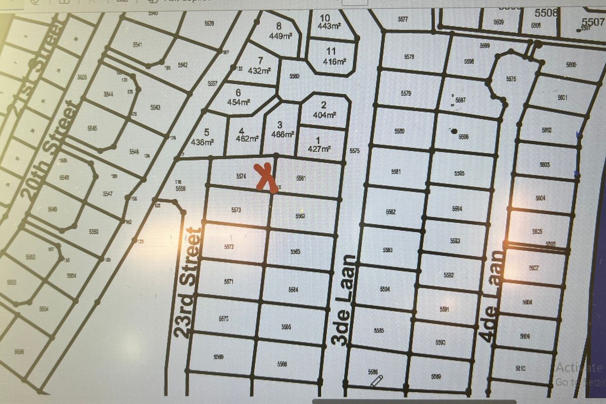 A digital cadastral map showing the layout and plot numbers of the residential estate, with a red mark indicating the specific property location.