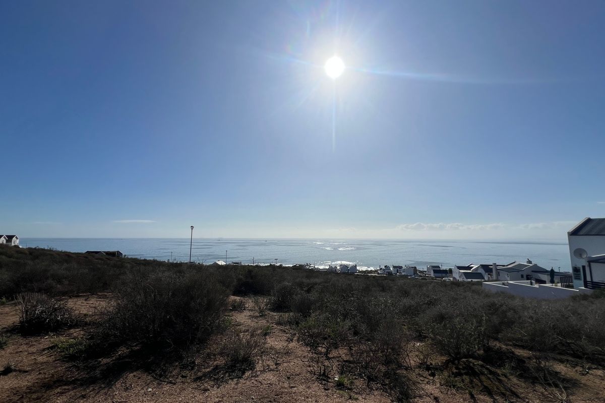A wide-angle view of the coastal landscape and ocean from the vacant residential property.