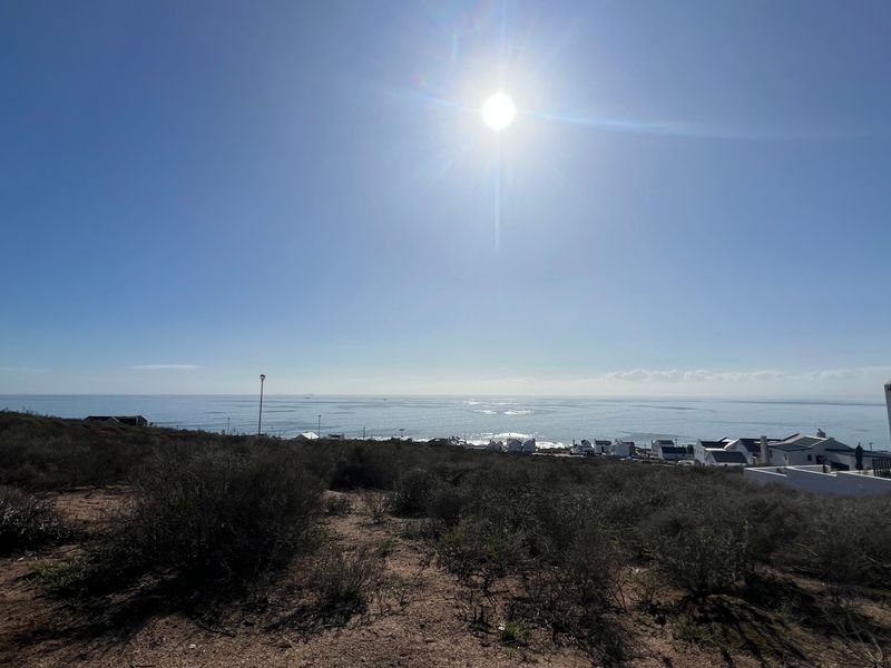 A wide-angle view of the coastal landscape and ocean from the vacant residential property.