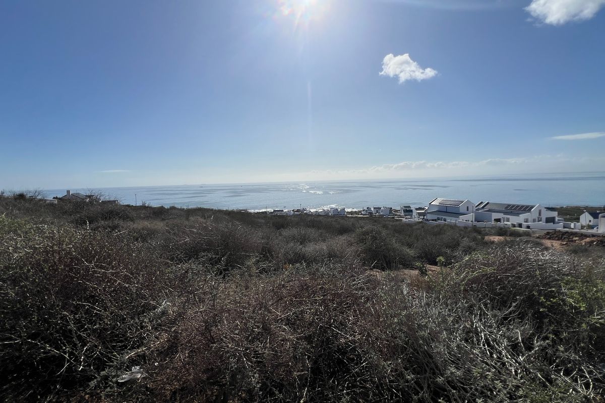 A wide-angle view of the coastal landscape and ocean from the vacant residential property.