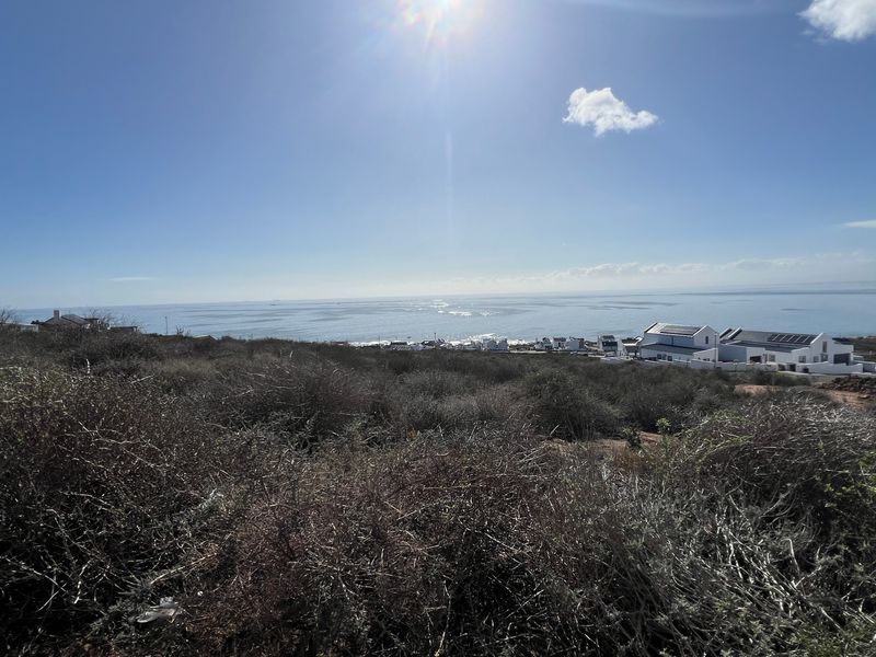 A wide-angle view of the coastal landscape and ocean from the vacant residential property.