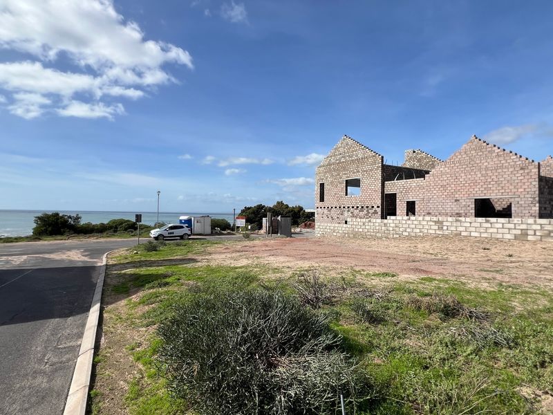 A residential property under construction featuring masonry block walls and a scenic coastal outlook.