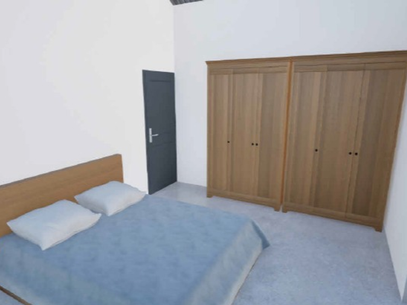 A bedroom featuring built-in wooden wardrobes and a neutral interior finish.