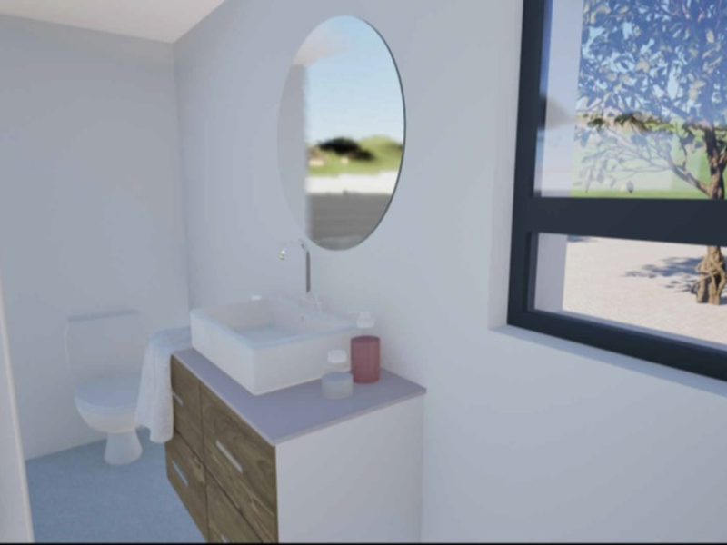 A modern, minimalist bathroom featuring a wood-finish vanity with a vessel sink, wall-mounted faucet, oval mirror, and a toilet, illuminated by natural light.
