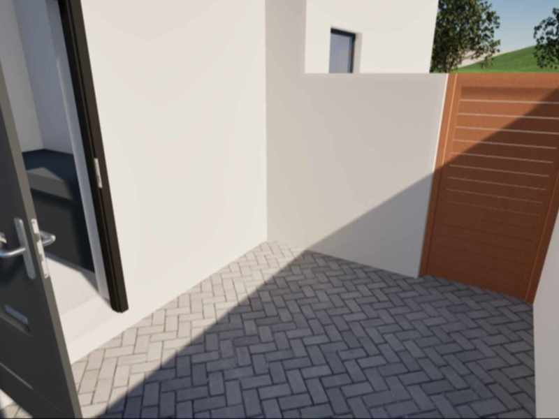 A clean, modern paved courtyard area featuring a timber slat gate and a contemporary entrance door.