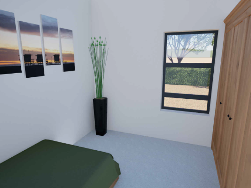 A bedroom featuring a built-in wooden wardrobe and a window with views of the garden.