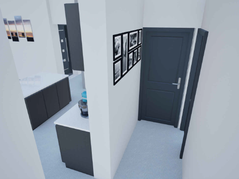 A modern kitchen area featuring dark cabinetry, a central island with stone countertops, and clean, minimalist finishes.