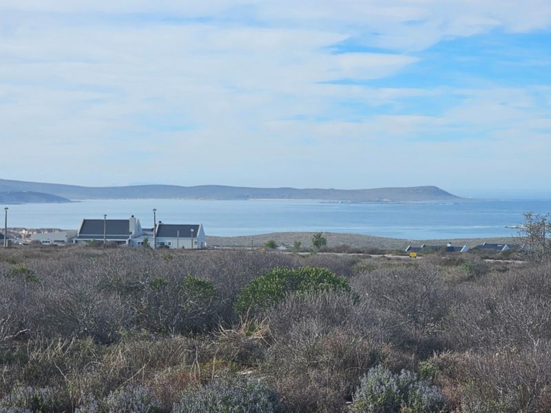 A scenic view overlooking the coastal landscape and ocean from the vacant residential property.
