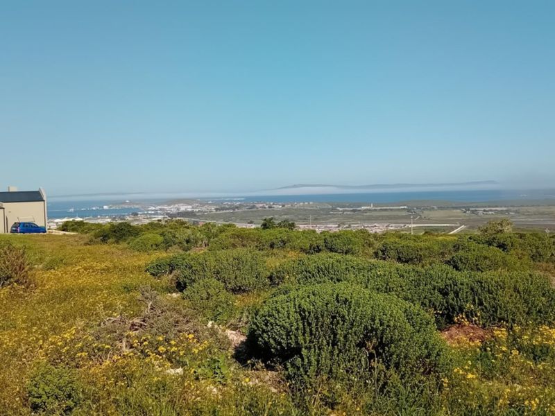 A scenic elevated view overlooking the coastal landscape and surrounding residential area, showcasing the natural terrain and horizon.