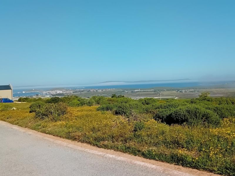 A scenic view overlooking the coastal landscape and surrounding terrain from the vacant residential property.