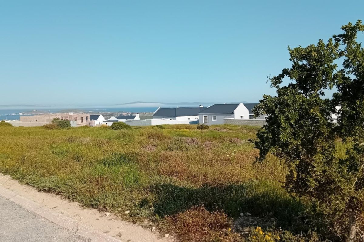 A view of the surrounding residential area and distant coastline from the vacant residential plot.
