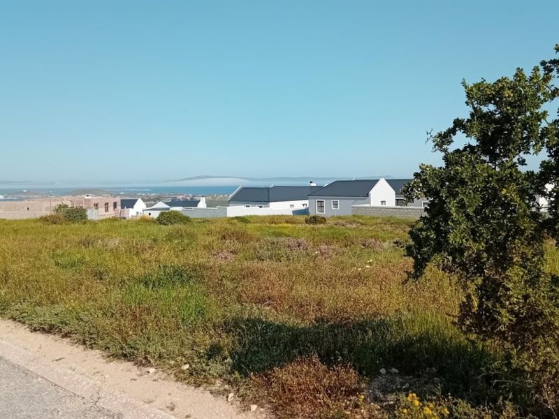 A view of the surrounding residential area and distant coastline from the vacant residential plot.