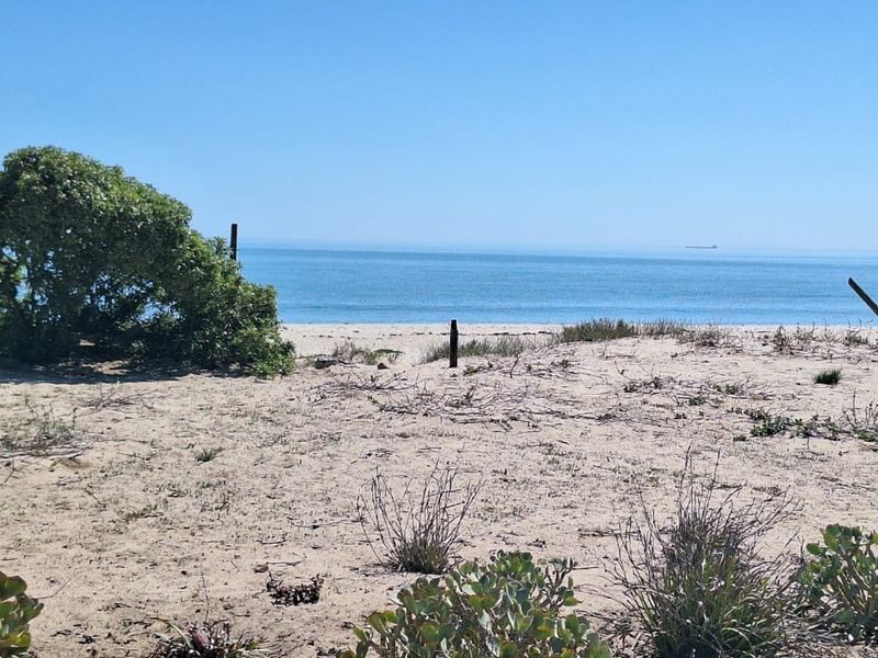 A scenic view of the sandy coastline and ocean horizon from the vacant residential property.