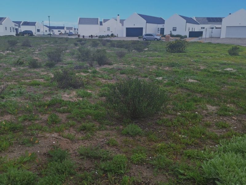 A vacant residential plot of land situated in a developed estate, offering a level building site with established surrounding homes.