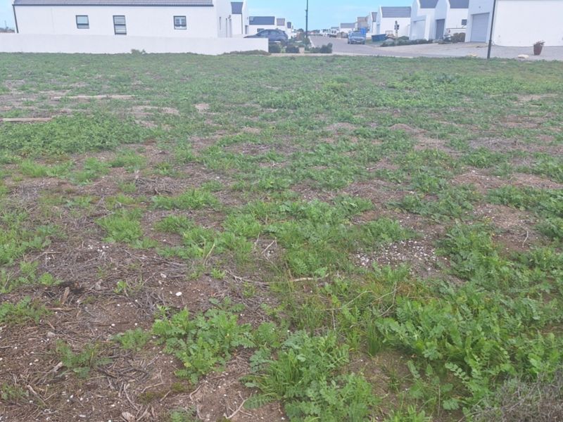 A vacant residential plot of land situated in a developed neighborhood, offering a clear space ready for new construction.