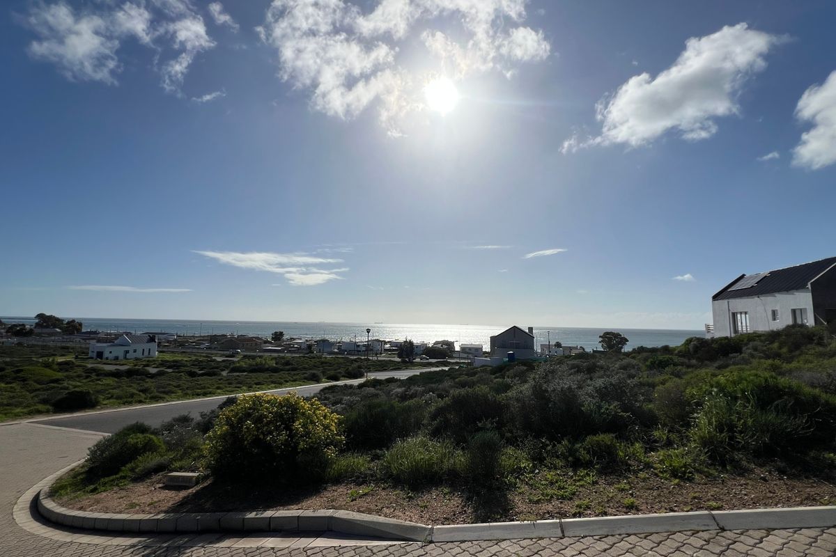 A scenic view of the coastal landscape and surrounding neighborhood, showcasing the property's elevated position and proximity to the ocean.