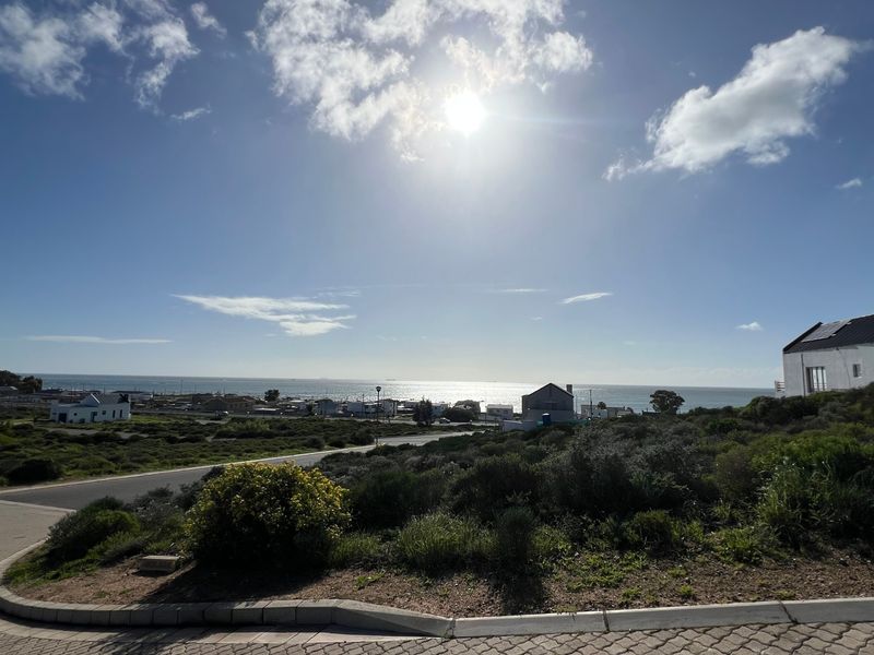 A scenic view of the coastal landscape and surrounding neighborhood, showcasing the property's elevated position and proximity to the ocean.