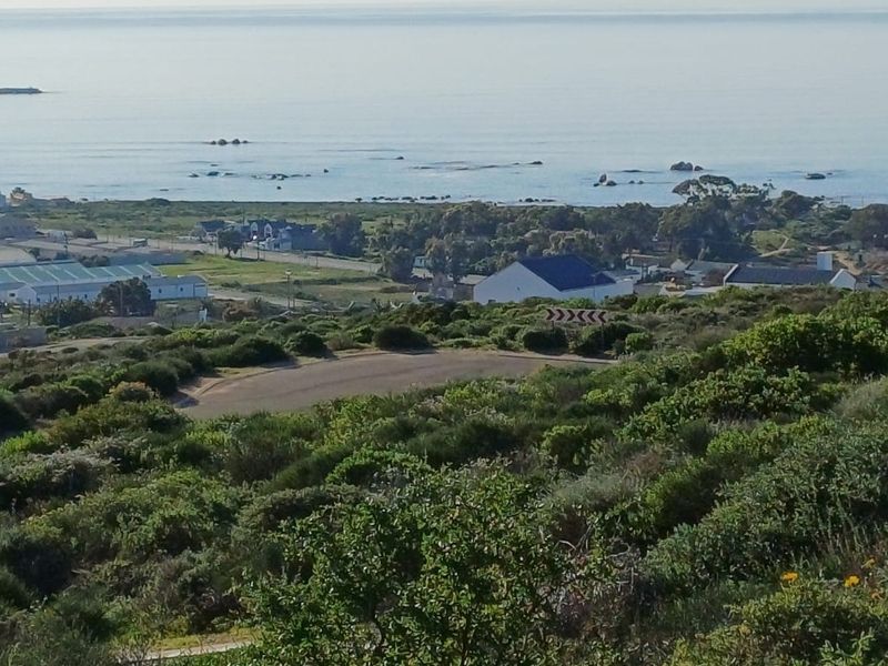 A scenic elevated view overlooking the coastal landscape, surrounding neighborhood, and ocean horizon.