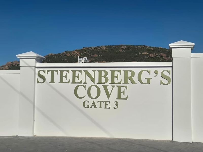 A clear view of the Steenberg's Cove Gate 3 entrance signage and boundary wall structure.