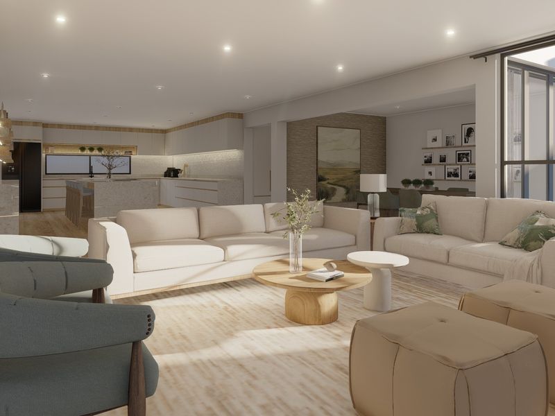 Spacious open-plan living area featuring a modern kitchen with stone island, recessed lighting, and seamless flow to the outdoor patio through large sliding doors.